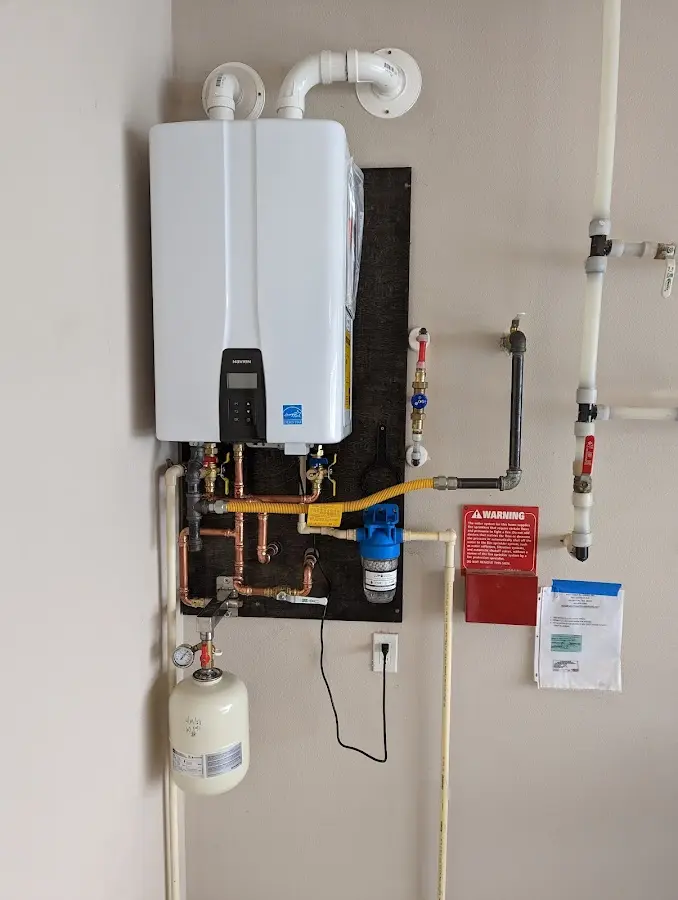 Professional plumber installing copper piping in a Pickerington home